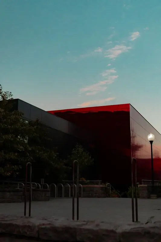 Modern building with a red facade at dusk