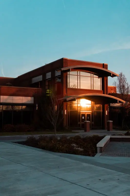 Brick building reflecting a sunset