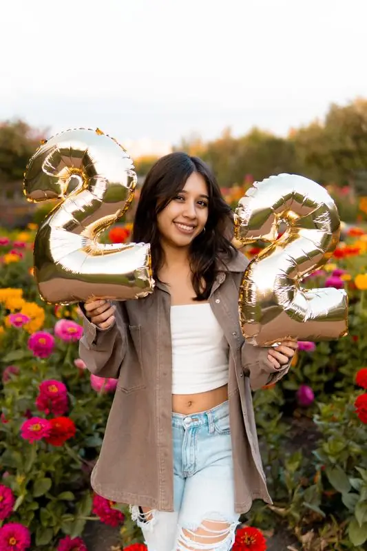 Portrait with gold 22 balloons in a garden