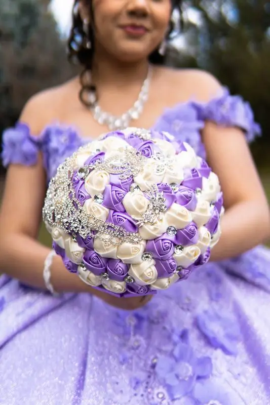 Young woman in a purple dress holding a bouquet