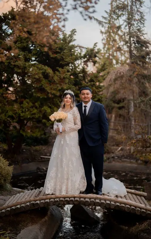 Bride and groom on a small wooden bridge