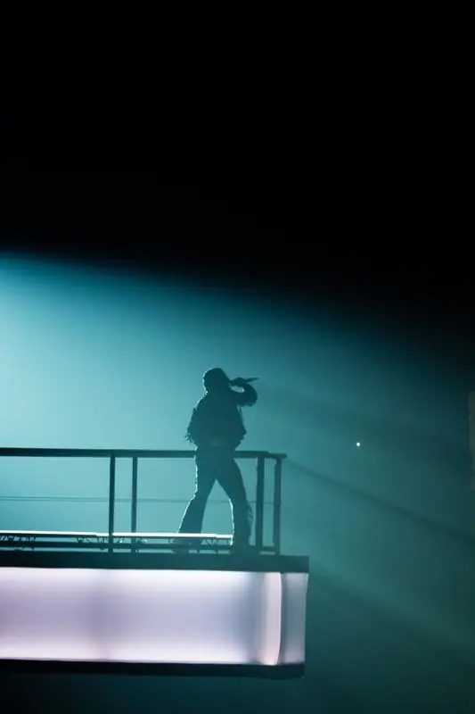 Silhouette of a performer on a suspended stage