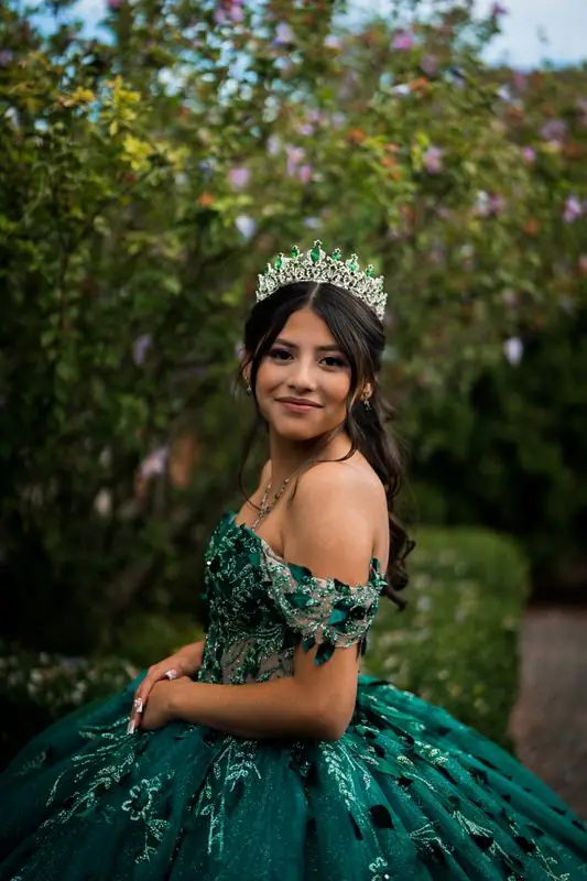 Quinceañera portrait in a green gown and tiara