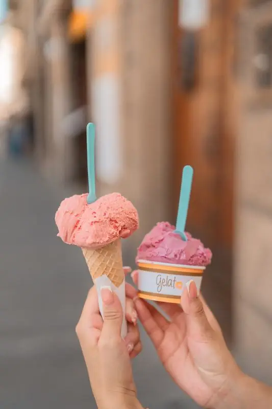 Two hands holding gelato