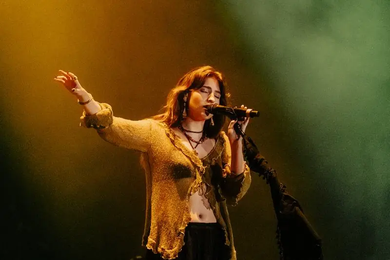 Singer in a beige sweater